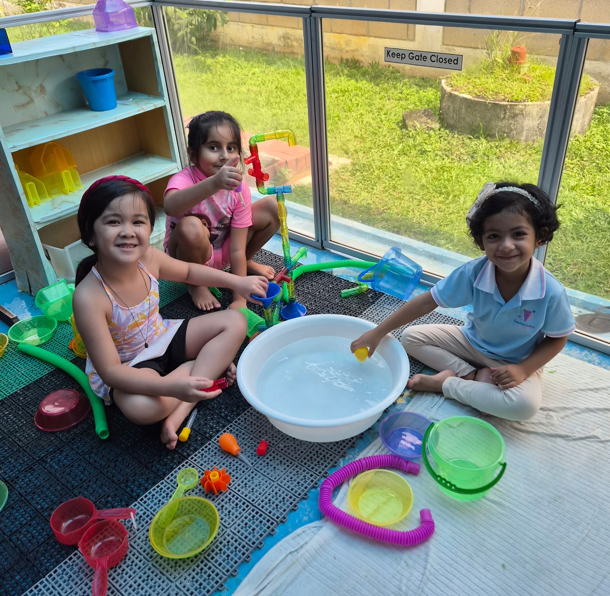 Children at Genius Gems Childcare Centre enjoying a water play session in Changi